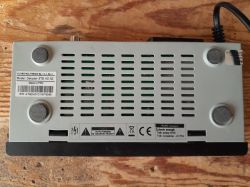 Bottom of DVB-T Opticum HD N2 set-top box with labels and ventilation holes