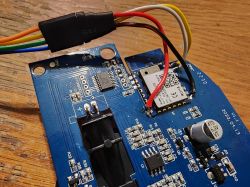 Close-up of a circuit board with connected wires, showing electronic components.