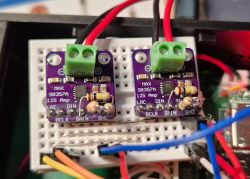 Two MAX98357A I2S amplifier modules on a breadboard with green terminals and wires.
