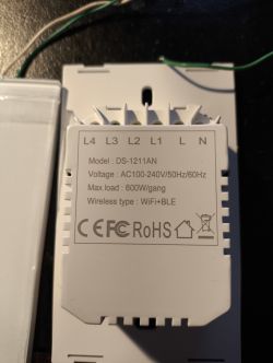 Close-up of the back of a control panel model DS-1211AN with voltage and connectivity information.