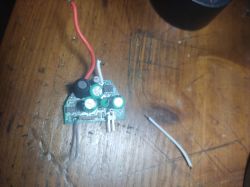 Electronic module from an RGB lamp on a wooden surface.