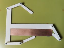 PCB alignment jig with clamping arms and copper-coated board