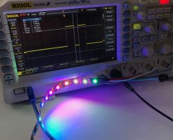 Oscilloscope and WS2812B LED Strip Oscilloscope displaying waveforms and a WS2812B LED strip connected to the device.