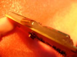 Close-up of the gap between the screen and PCB filled with adhesive.