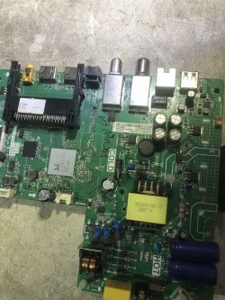 Partially repaired Thomson 32HZ5006 TV mainboard lying on a workbench