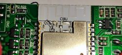 Close-up of a circuit board with integrated circuits and markings.