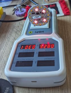 Photo of a round LED circuit board placed on an electrical meter.