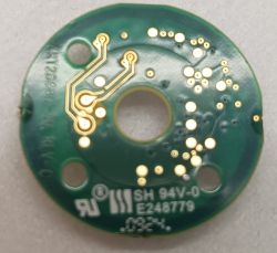 Image of a printed circuit board with visible traces and mounting holes.
