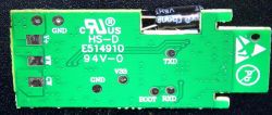 Close-up of the back side of a printed circuit board with markings.