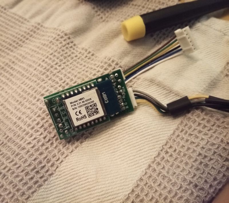 WBR3 Wi‑Fi module on a small PCB with wires and connectors, lying on a light blanket