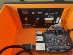 Raspberry Pi board and OSOYOO screen inside an orange enclosure with connected cables