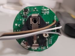 Close-up of a circuit board inside a smart power socket with visible wires.