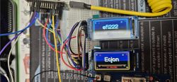 Breadboard prototype with wires and two blue LCD displays showing “efi222” and “Ecjon”