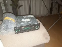 Car stereo on a stool with a backlit display reading “Bohema Radio” and two control knobs