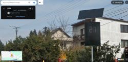 Roadside radar sign displaying a speed of 27 km/h with a solar panel on top.