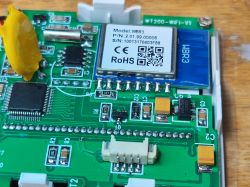 Close-up of thermostat PCB showing WBR3 Wi‑Fi module, MCU chip, and SMD components