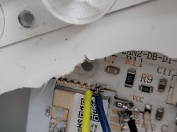 Close-up of a circuit board with soldered wires and labeled components