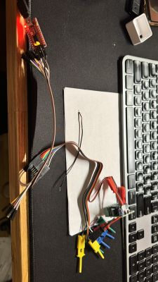 UART cables connected to a board next to a keyboard.
