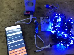 Testing LED Set with OpenBeken Controller LED set with bright blue lights, smartphone, and a power meter