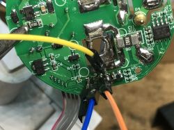 Programming the SWP86-01OG WiFi Socket PCB Close-up of a WiFi socket PCB with wires soldered for firmware flashing.