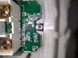 Close-up of a printed circuit board with electronic components inside a plastic housing.