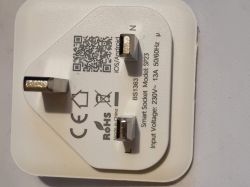 Back of a white smart socket with three UK pins, a QR code, and printed electrical markings