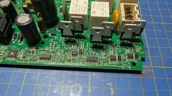 Zbliżenie płytki PCB z kondensatorami, przekaźnikami i tranzystorami mocy