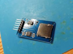 MicroSD card reader module on a blue PCB