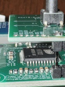 Close-up of two stacked printed circuit boards with various electronic components.