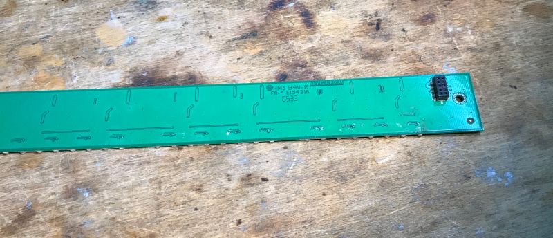 Printed Circuit Board with Markings on the Bottom Photo of a green printed circuit board bottom side with markings.