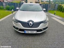 A silver Renault car parked on a driveway with the license plate KRA 989CG visible.