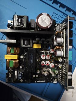 Widok z góry na wnętrze zasilacza DeepCool PN750M z widocznymi elementami elektronicznymi