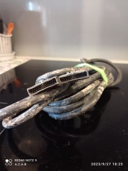 Close-up of a tangled, used cable with two DVI connectors at the end.