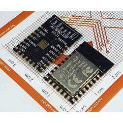 Two AI-WB2-12F modules lying on graph paper.
