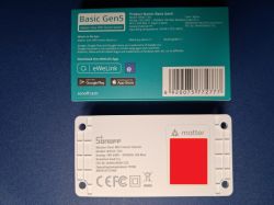 Box and white Sonoff Basic Gen5 (BASIC-1GS) smart switch module on a blue surface