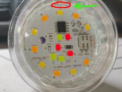 Close-up of a circular LED board with RGBW diodes and circuit components in a plastic case