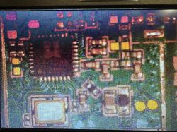 Macro view of electronics on a green PCB with an integrated circuit and SMD components