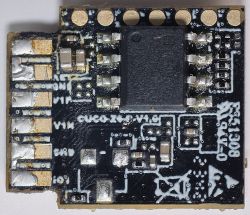 Close-up of a PCB with various electronic components and labels.