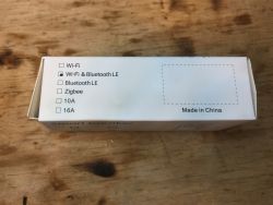 White box with Wi-Fi and Bluetooth LE marking on a wooden background.