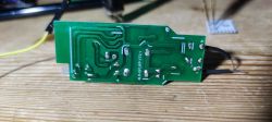 Close-up of a green PCB with markings and electrical traces.