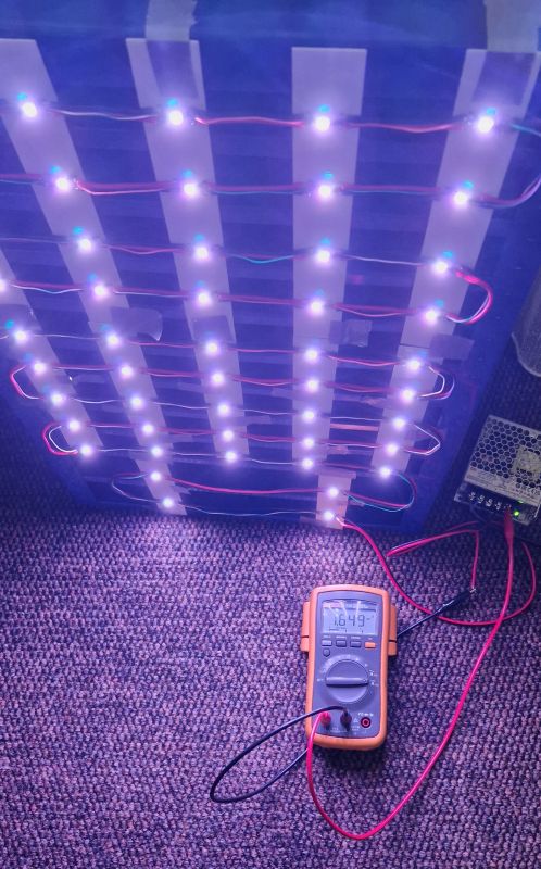 LED Panel with Multimeter LED panel connected with wires to a multimeter on the floor.