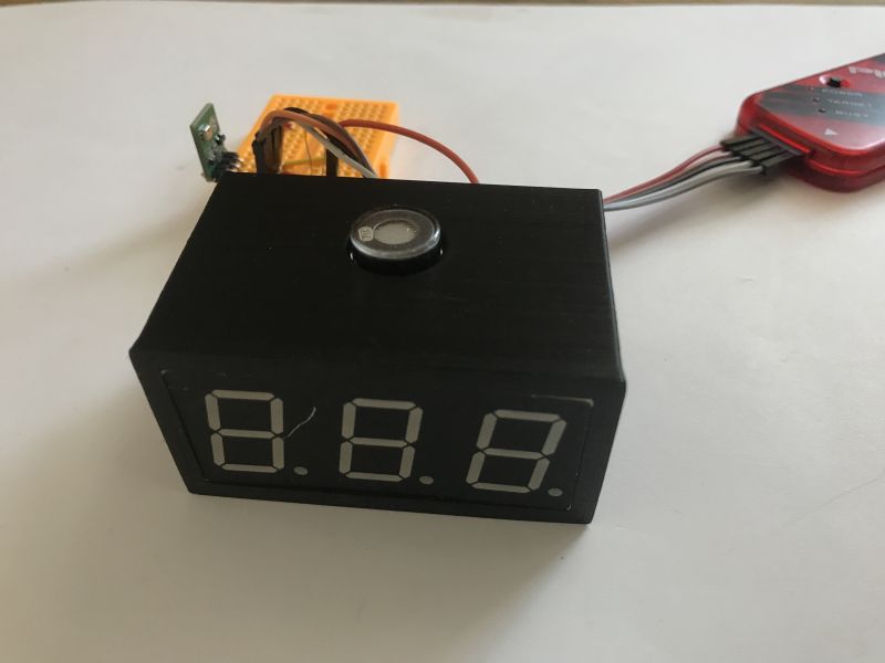 A prototype plastic enclosure fitted to a 3-digit 7-segment display, attached to an electronics board.