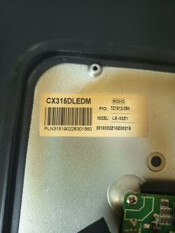Label with model number CX315DLEDM attached to a metallic device surface