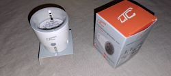 Smart WiFi Socket with Packaging Smart WiFi socket next to its original packaging on a table.