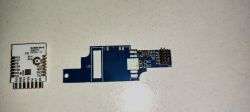PCB Boards with WiFi Module and Electronic Components Two PCB boards, one white with pin labels, the other blue with electronic components.