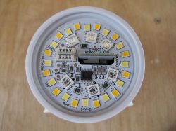 Close-up of the interior of an LED bulb with visible LEDs and electronic components on a circuit board.