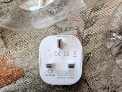 Back of ANTELA Smart Plug Close-up of the back of an ANTELA smart plug on fabric background.
