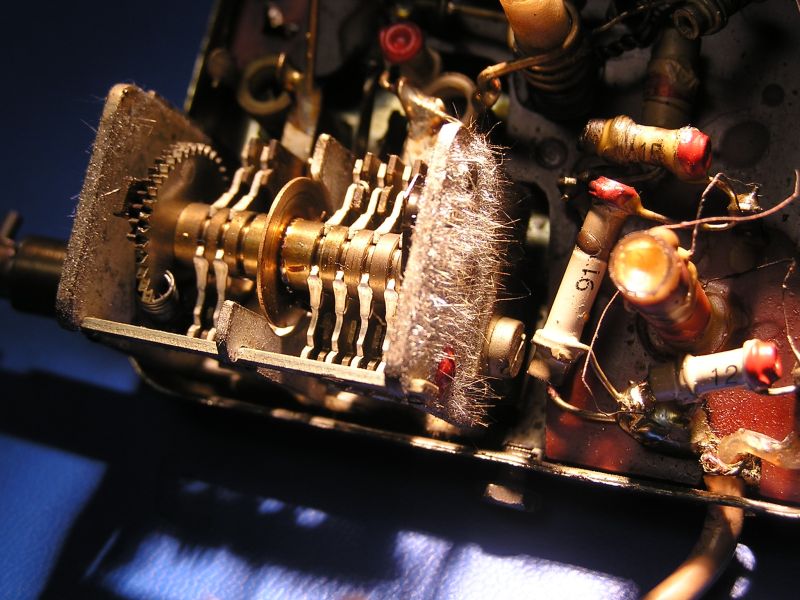 Close-up of a capacitor covered with dense, thin tin whiskers