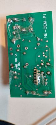 Green circuit board with markings HE-OEM-P1 and various components.