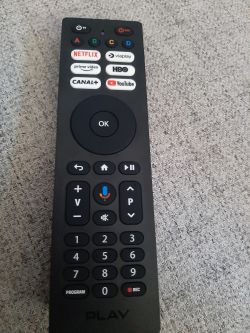 TV remote control with buttons for apps like Netflix and YouTube.